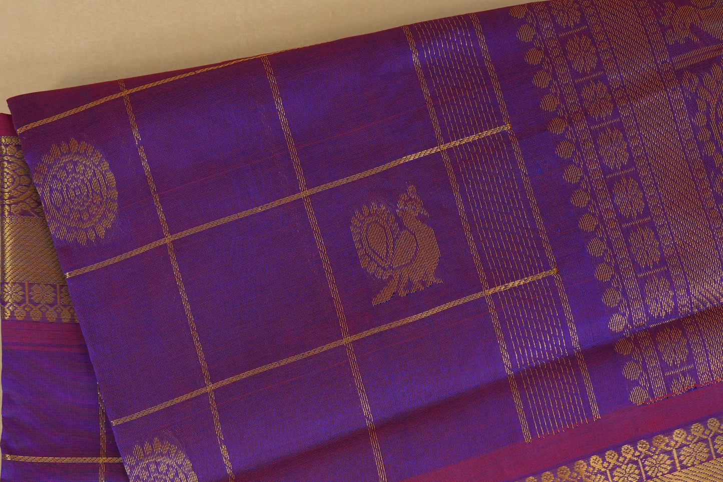 Purple fabric with gold patterns and silk cotton , nine and a half yards saree, close up
