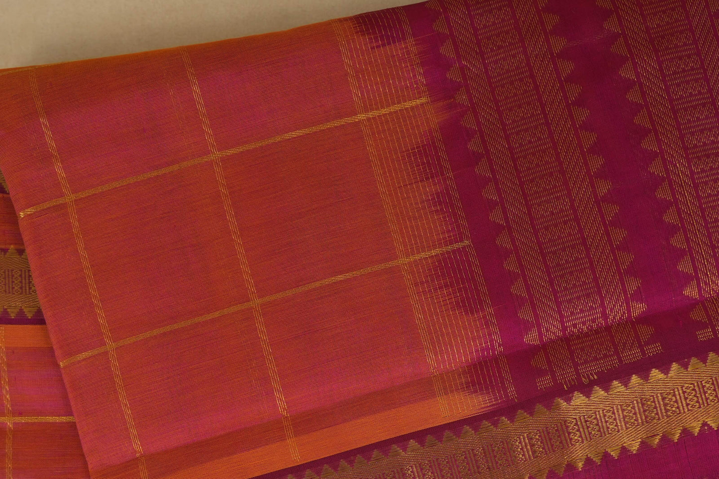 Traditional saree with pink and orange checkered pattern on a plain background, silk cotton , nine and a half yards saree, close up