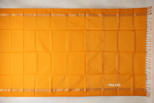Mango yellow Maheshwari silk cotton saree pallu laid flat, with narrow patterned borders, subtle vertical stripes and tassels at the end.