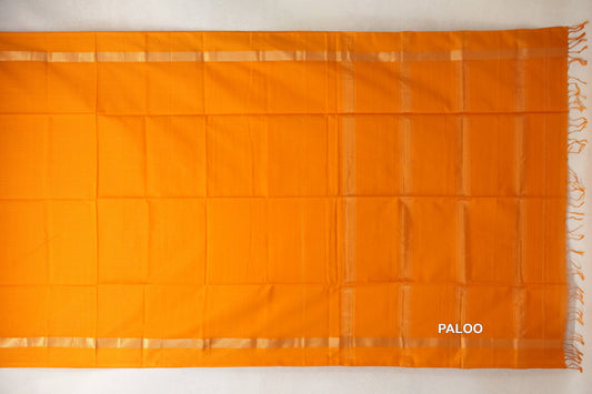 Mango yellow Maheshwari silk cotton saree pallu laid flat, with subtle vertical stripes, narrow woven borders and tassels at one end.