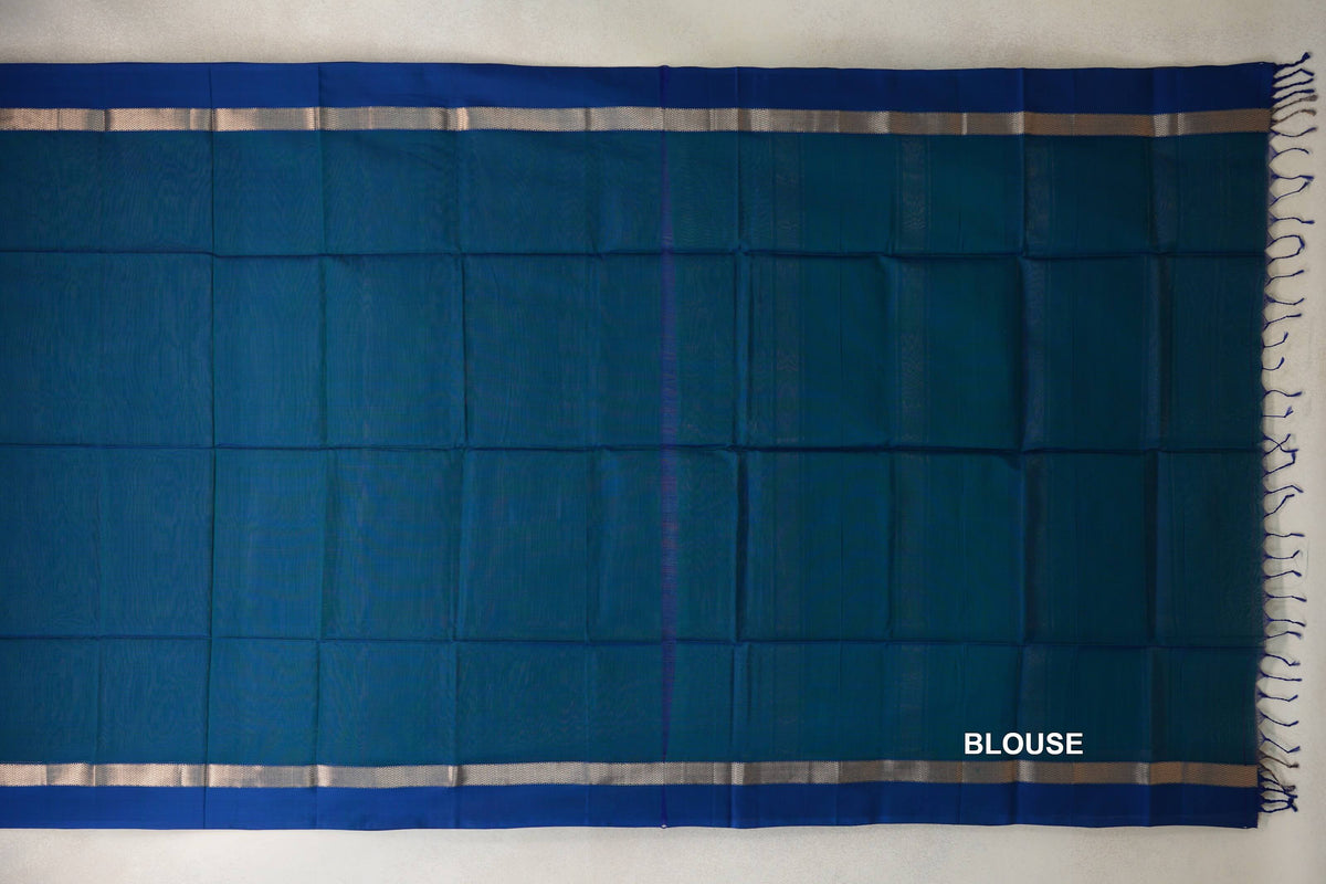 Peacock blue Maheshwari silk cotton blouse piece laid flat, with narrow silver-toned borders along the top and bottom and blue tassels at one end.
