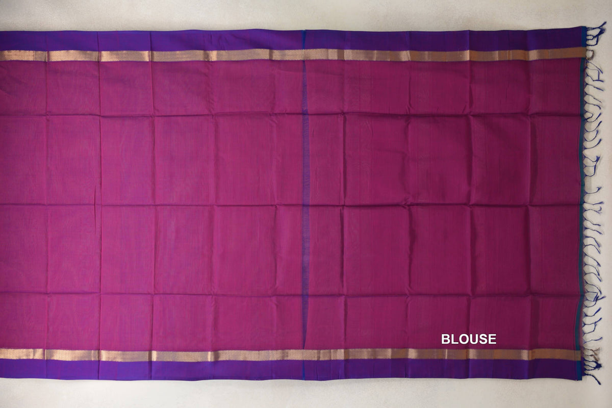 Laid-flat Maheshwari silk cotton saree and deep magenta blouse piece, with violet purple borders, gold-toned stripes and tassels at one end.