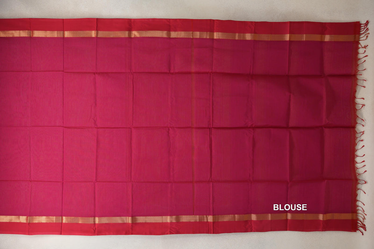 Maheshwari silk cotton blouse piece laid flat in bright rani pink, with deep rani pink borders, gold-toned stripes and tassels at one end.