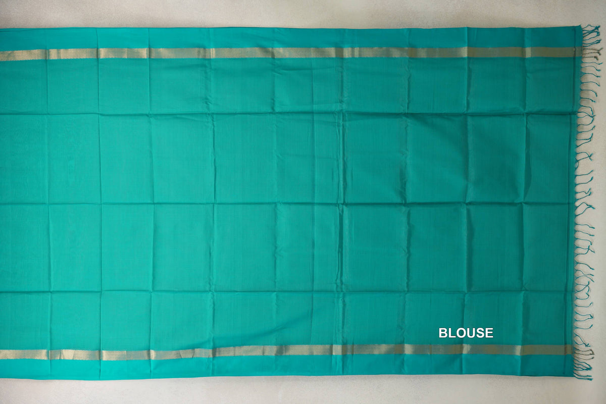 Bright aqua green Maheshwari silk cotton blouse piece laid flat, with narrow gold-toned woven borders and tassels along one edge.