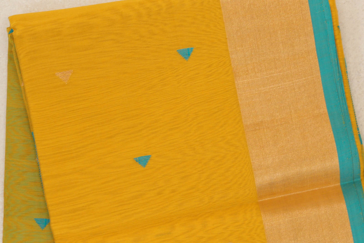 Close-up of a folded mustard yellow Maheshwari silk cotton saree with small turquoise and pale gold triangles, a broad golden border and turquoise blue edge.