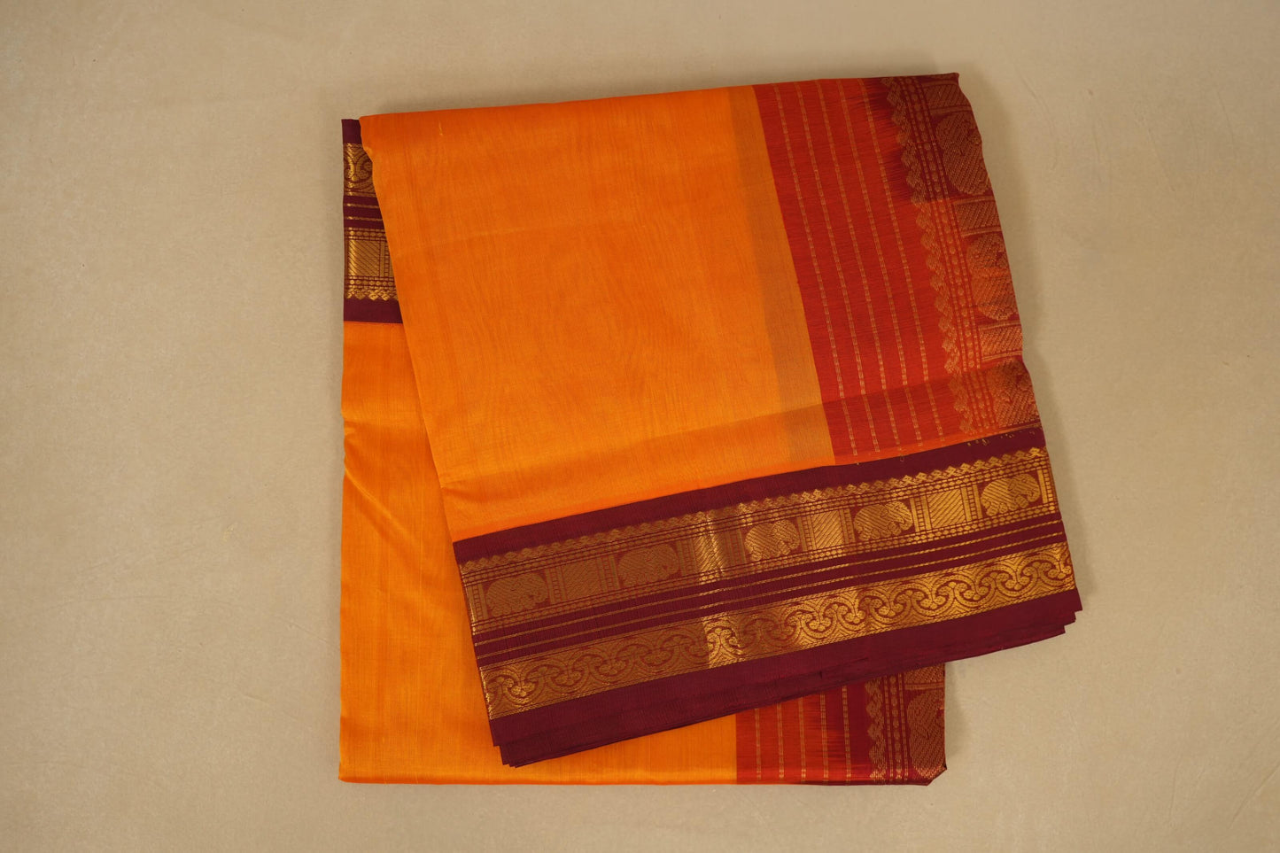 folded Orange with Dark Maroon Borders Silk Cotton Saree 