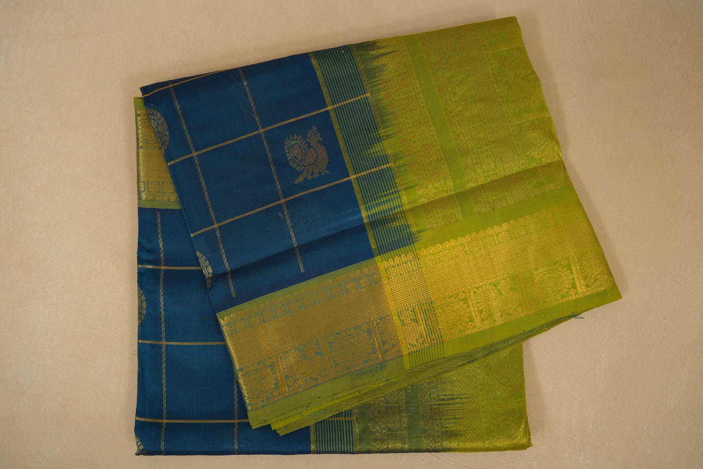 Blue and green checkered fabric with a pattern on a beige background, silk cotton , nine and a half yards saree, folded