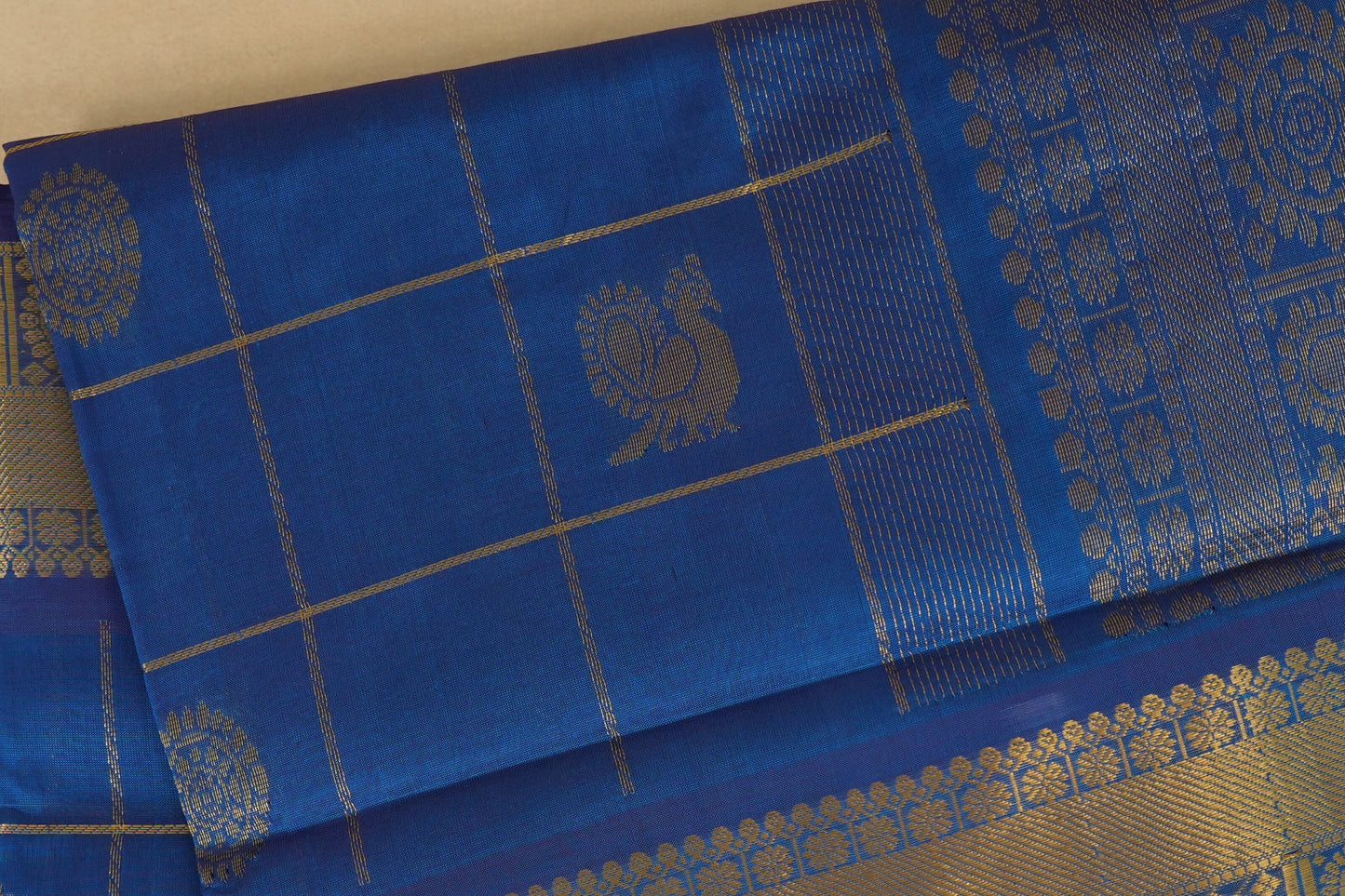 Blue sraee with gold patterns and a peacock design,  silk cotton , nine and a half yards saree, close up