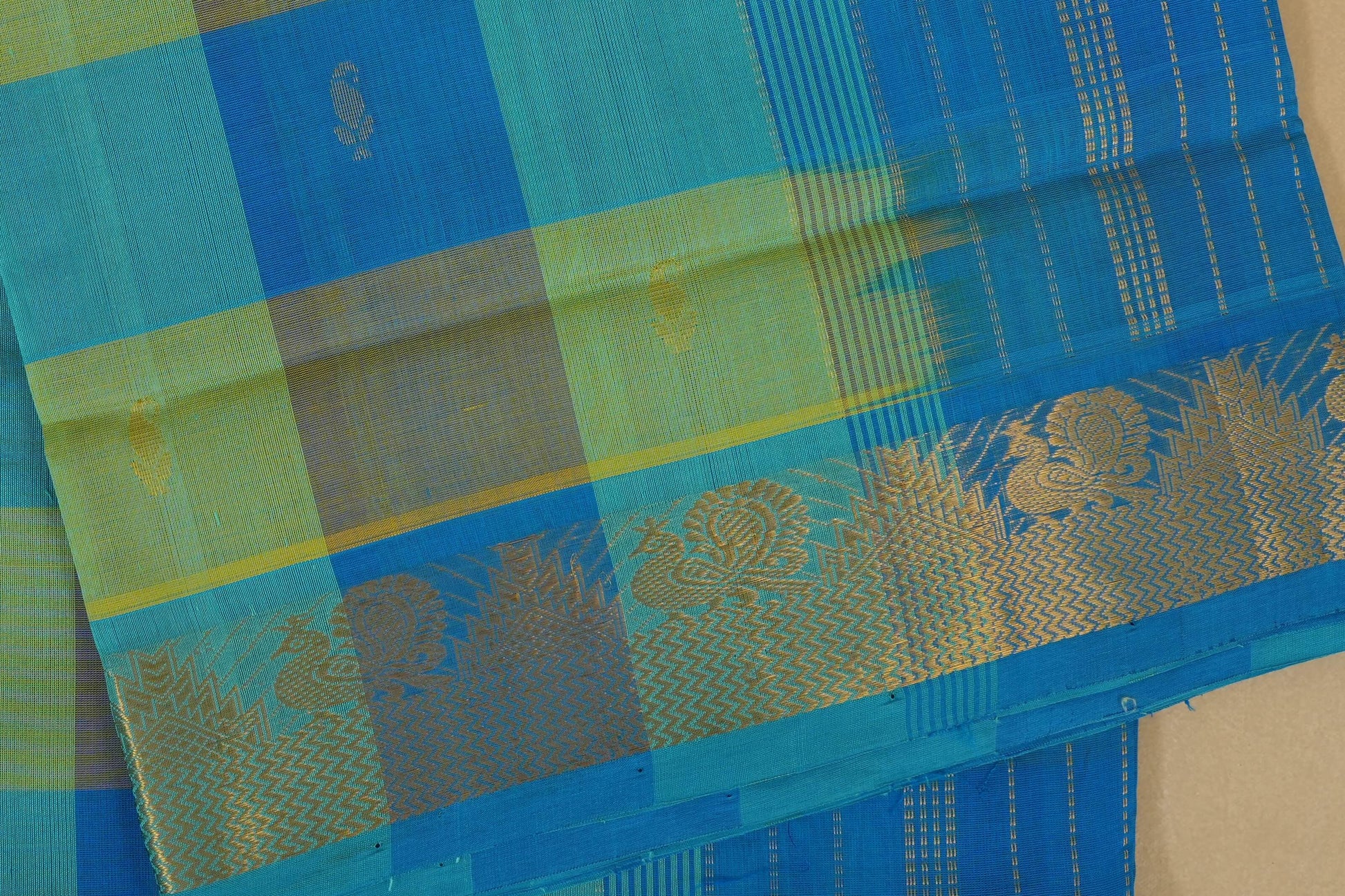 Blue and green fabric with gold patterns, close up, silk cotton , nine and a half yards saree