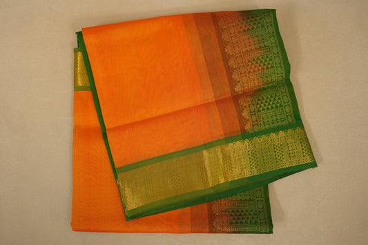 Orange and green saree with a patterned border on a beige background , silk cotton , nine and a half yards saree folded