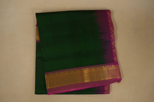 Green saree with gold and pink border on a beige background, silk cotton , nine and a half yards saree, folded