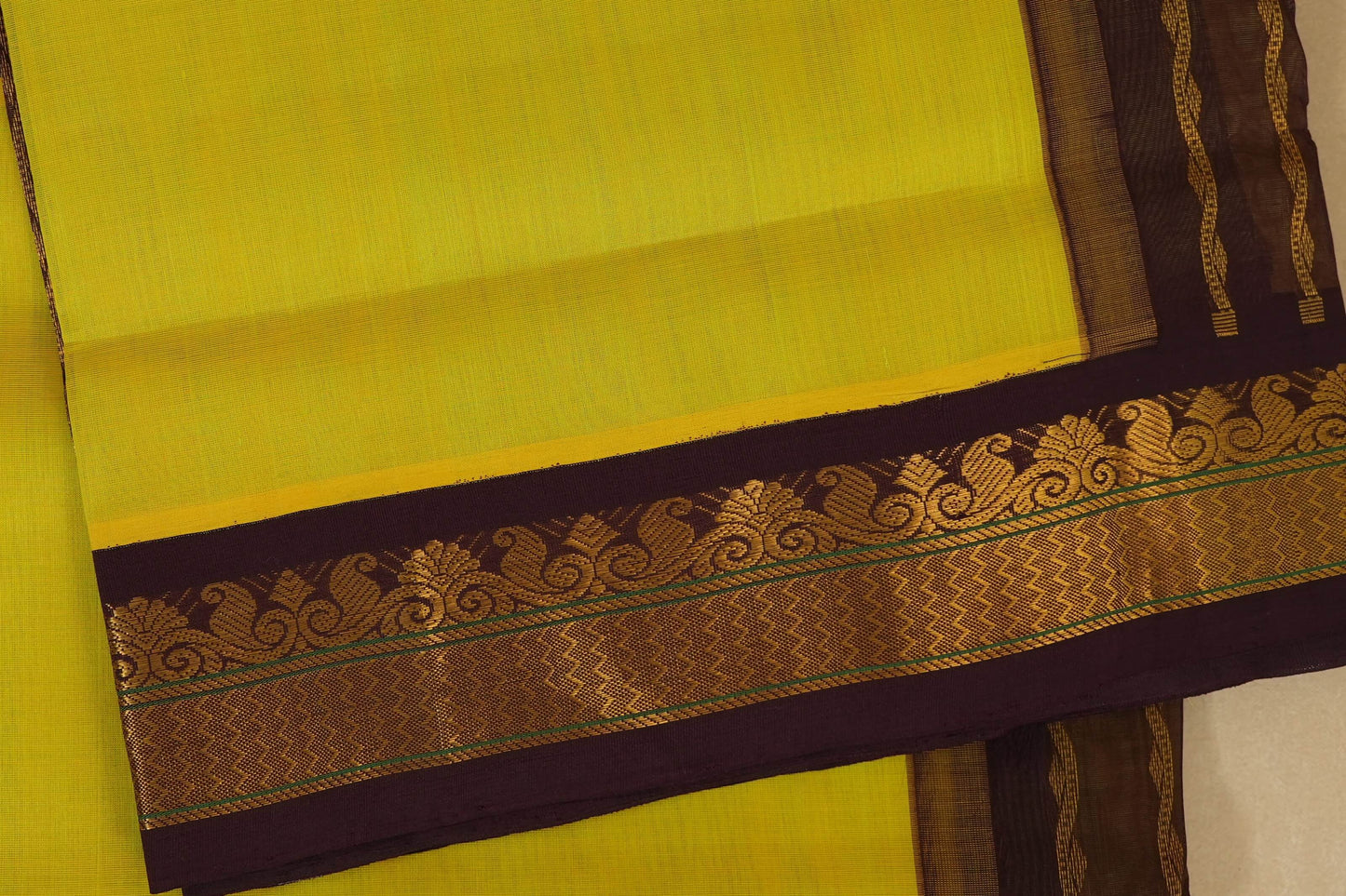 Yellow saree with a decorative brown and gold border , silk cotton , nine and a half yards saree