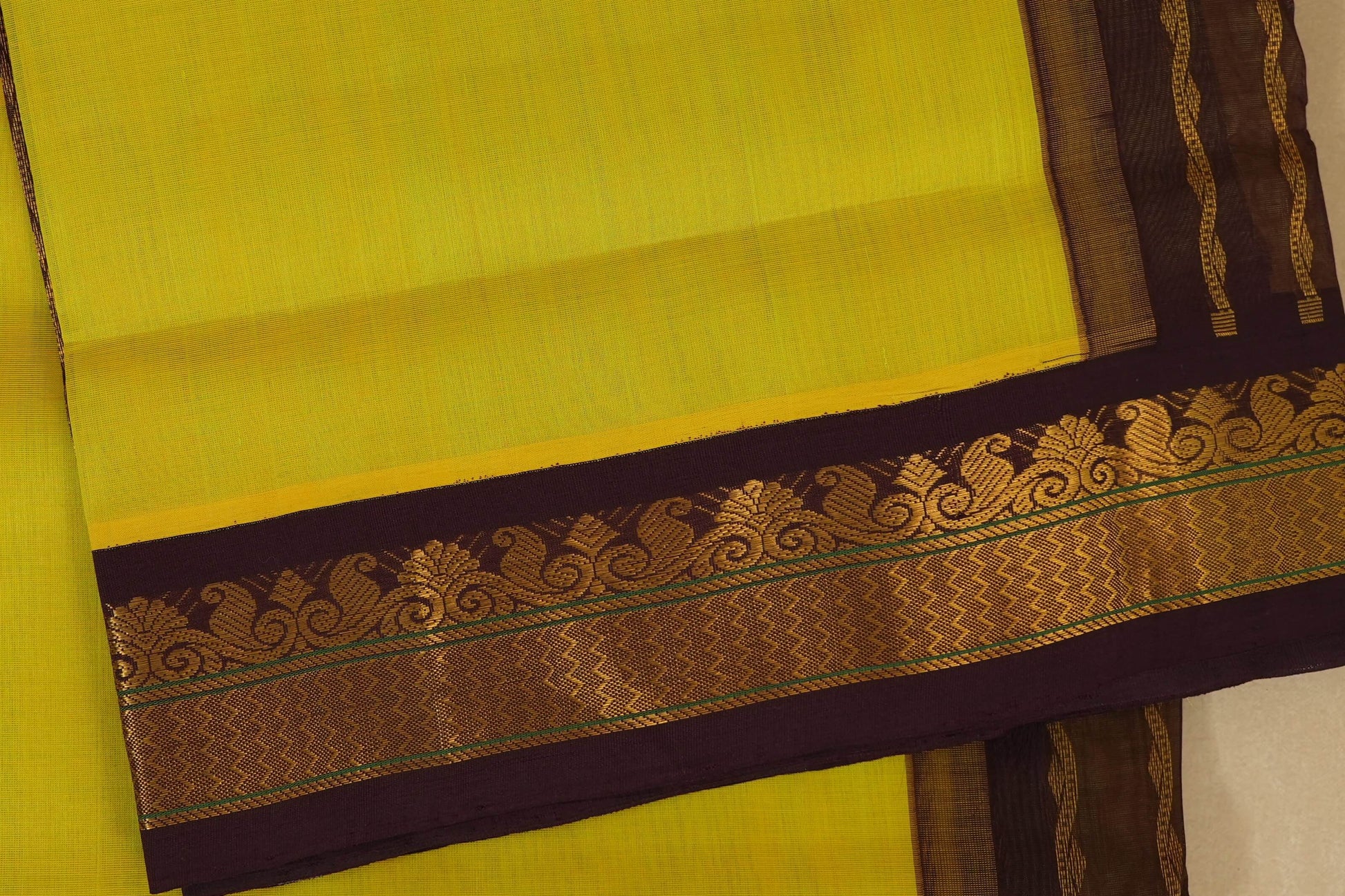 Yellow saree with a decorative brown and gold border , silk cotton , nine and a half yards saree