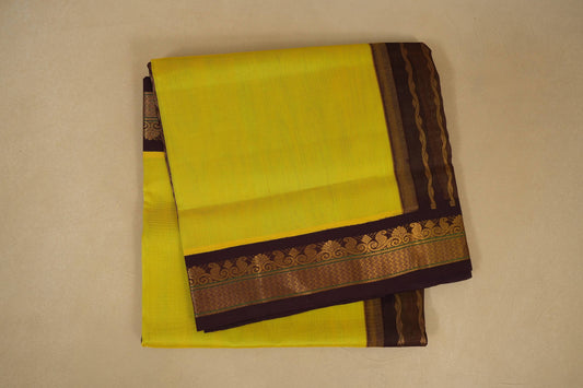 Yellow saree with a brown border on a beige background , silk cotton , nine and a half yards saree folded