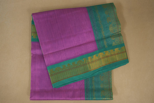 Purple and green traditional saree with a decorative border on a beige background, silk cotton , nine and a half yards saree folded
