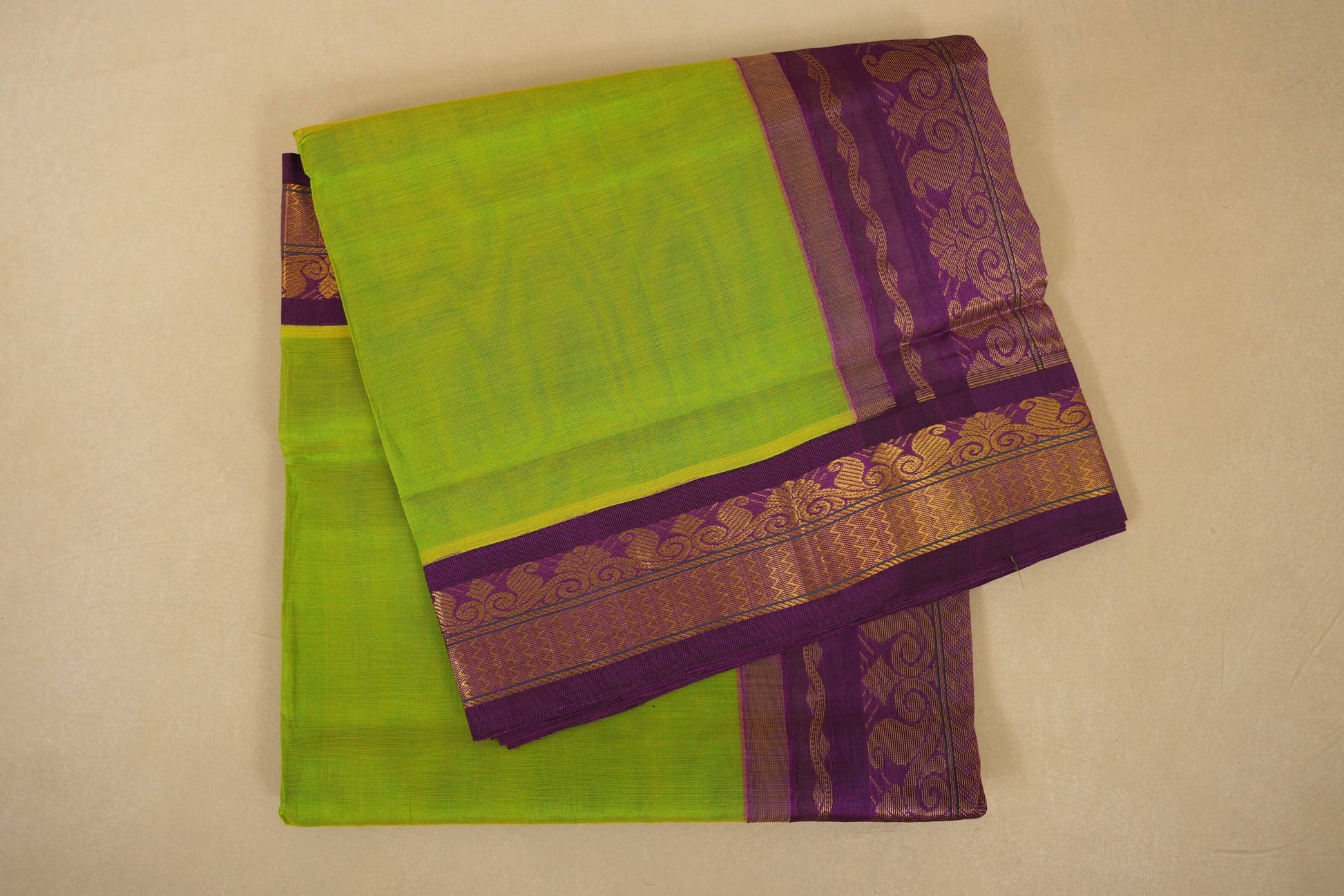 Green saree with purple border on a beige background, silk cotton , nine and a half yards saree