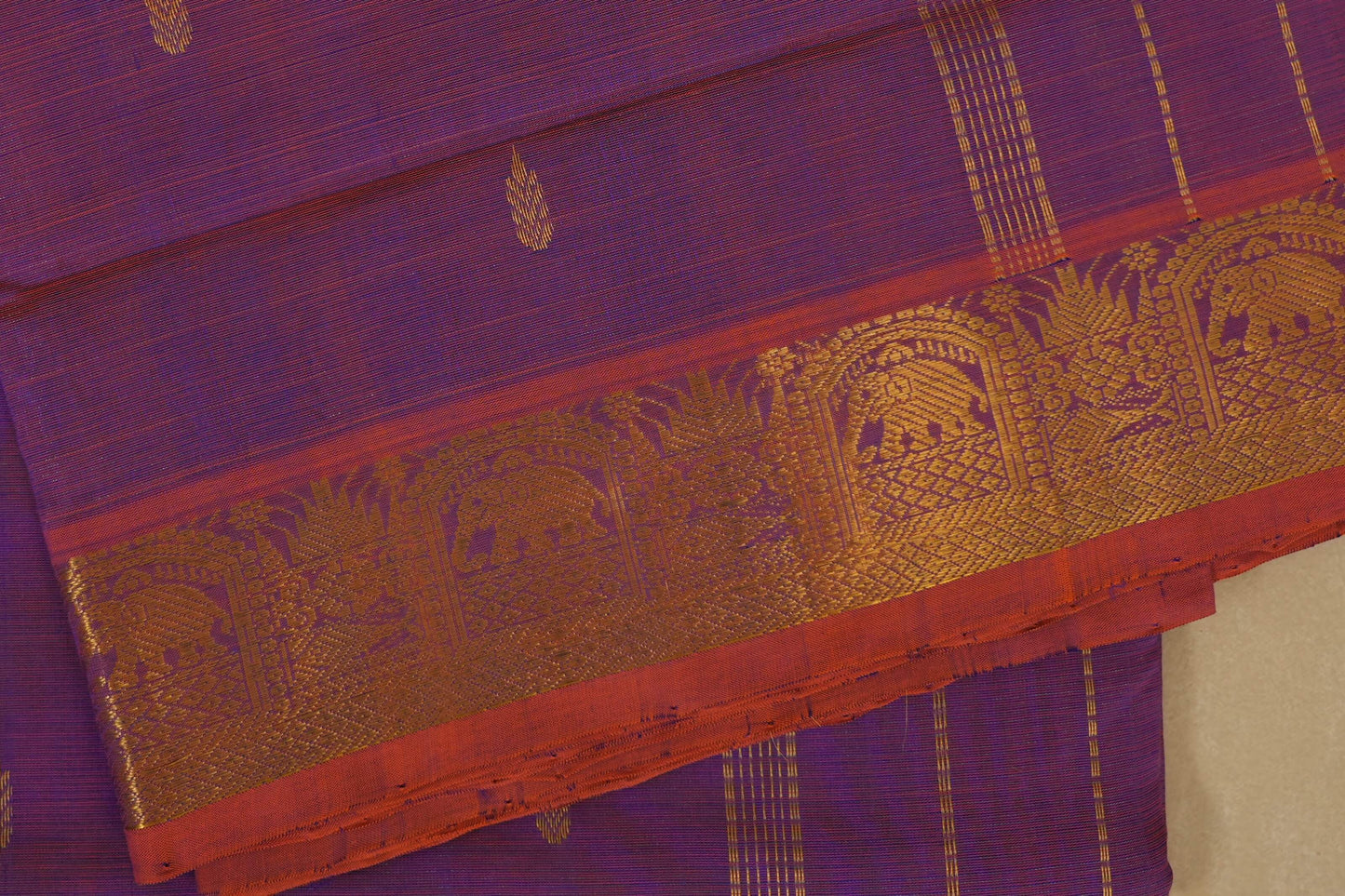 Purple fabric with gold and red patterns Close up