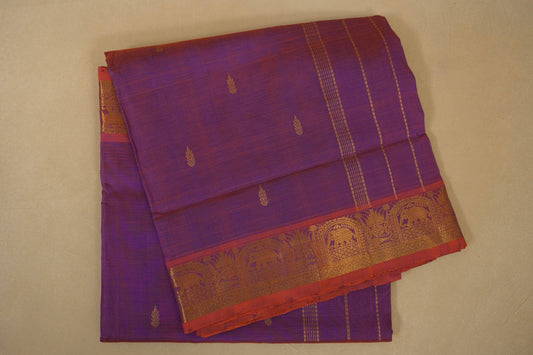 Purple saree with gold and red border on a beige background folded
