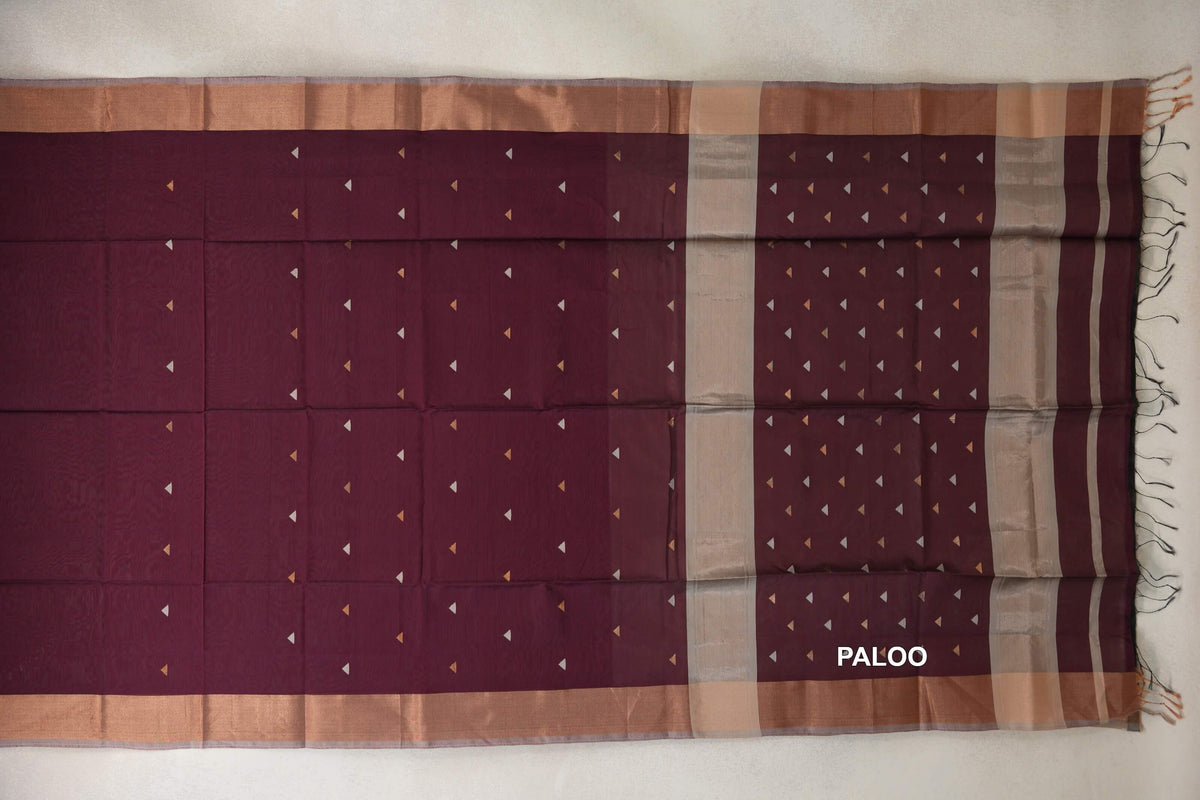 Maheshwari silk cotton saree pallu spread flat in deep wine maroon, with small triangular accents, broad borders, silver grey bands and tassels.