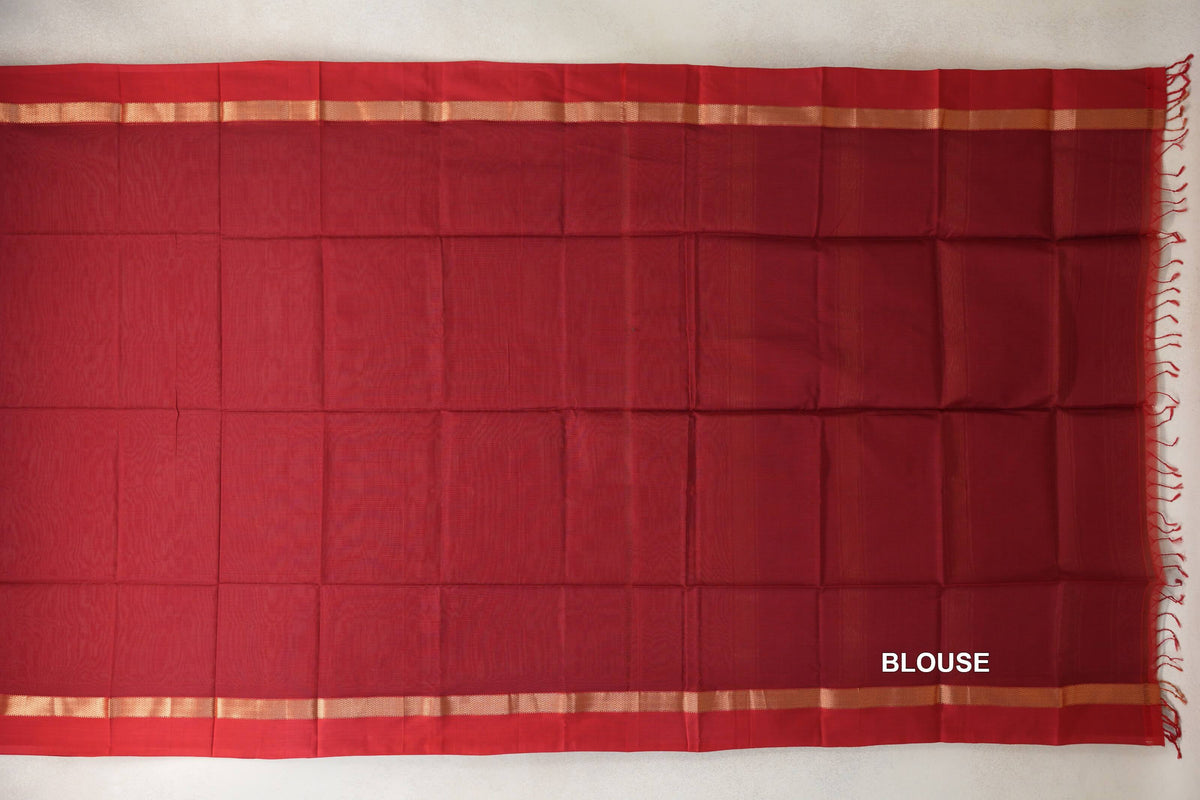 Deep red Maheshwari silk cotton blouse piece laid flat, with narrow gold-toned borders and red tassels along one edge.