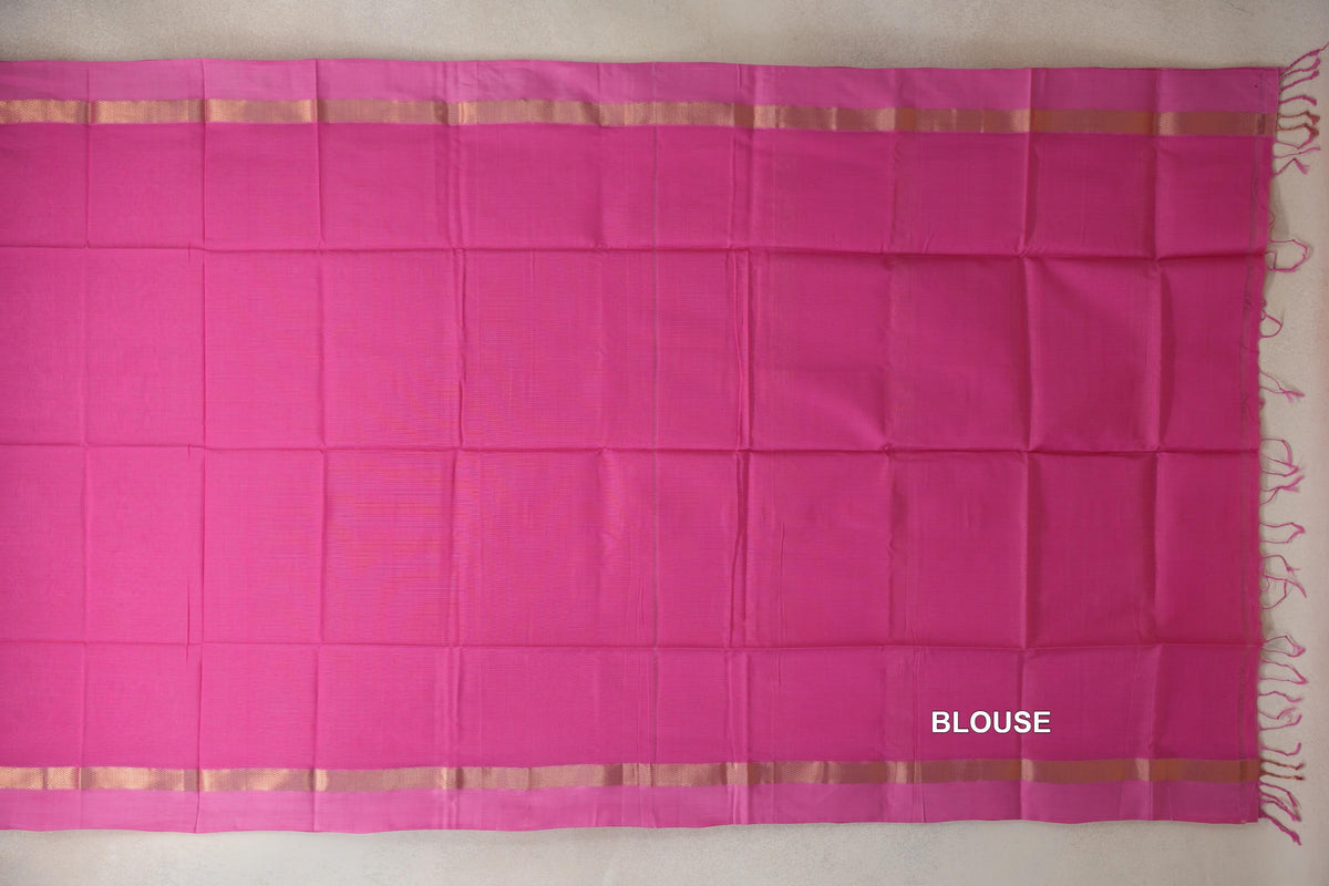 Bright rani pink Maheshwari silk cotton blouse piece laid flat, with pink borders, gold-toned woven bands and tassels along one edge.
