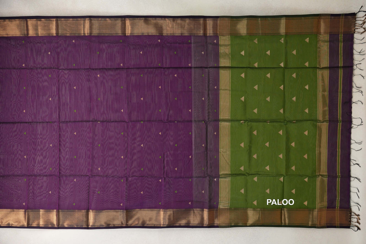 Spread-out Maheshwari silk cotton saree with a deep purple body, olive green pallu, small triangle motifs, patterned borders and end tassels.