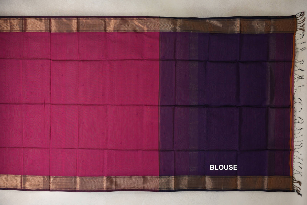 Unfolded Maheshwari silk cotton saree showing a deep rani pink body beside a deep purple blouse piece, with patterned borders and tassels.