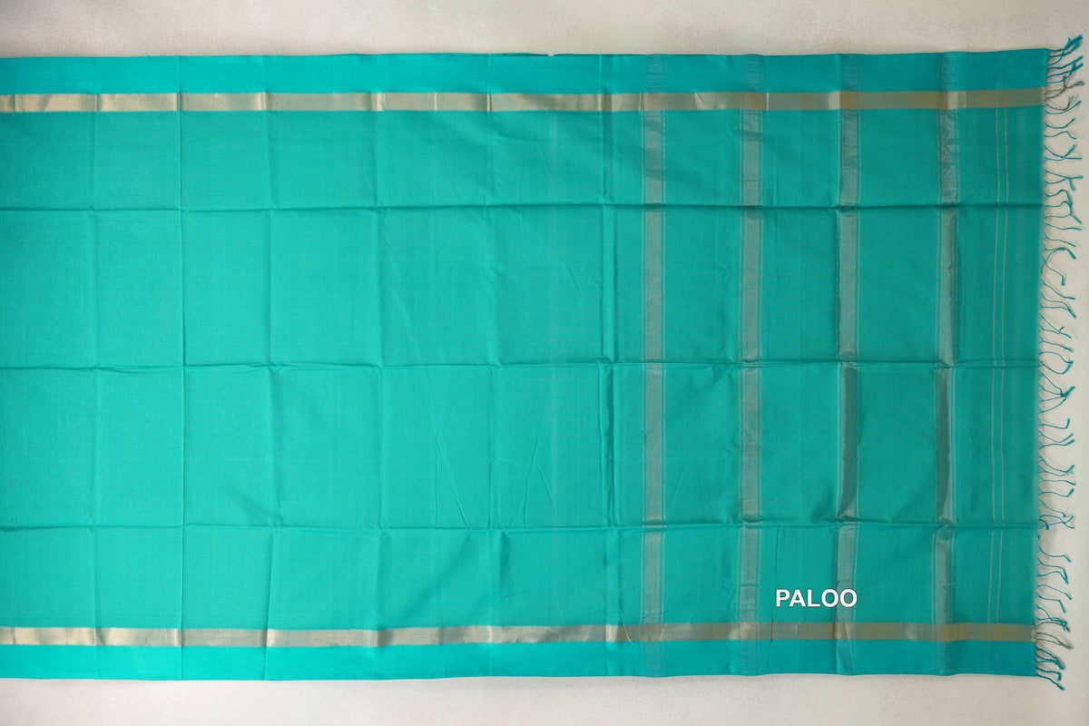 Bright aqua green Maheshwari silk cotton saree spread flat, with a plain body, pale metallic borders and a striped pallu with tassels.