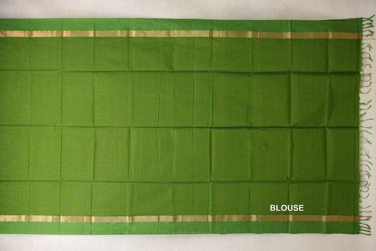 Leaf green Maheshwari silk cotton blouse piece laid flat, with a plain body, narrow gold-toned borders and fringe along one end.