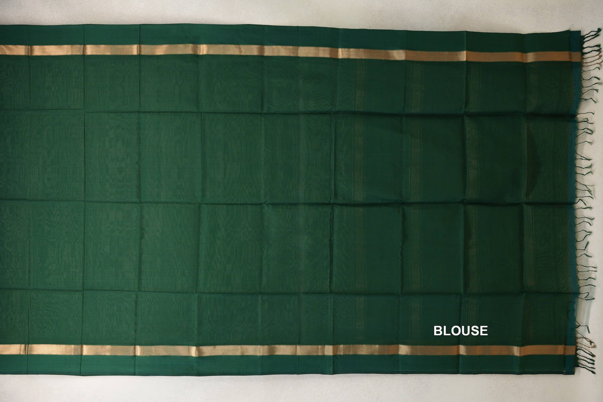 Deep bottle green Maheshwari silk cotton blouse piece laid flat, with narrow gold-toned bands along both edges and fringe at one end.