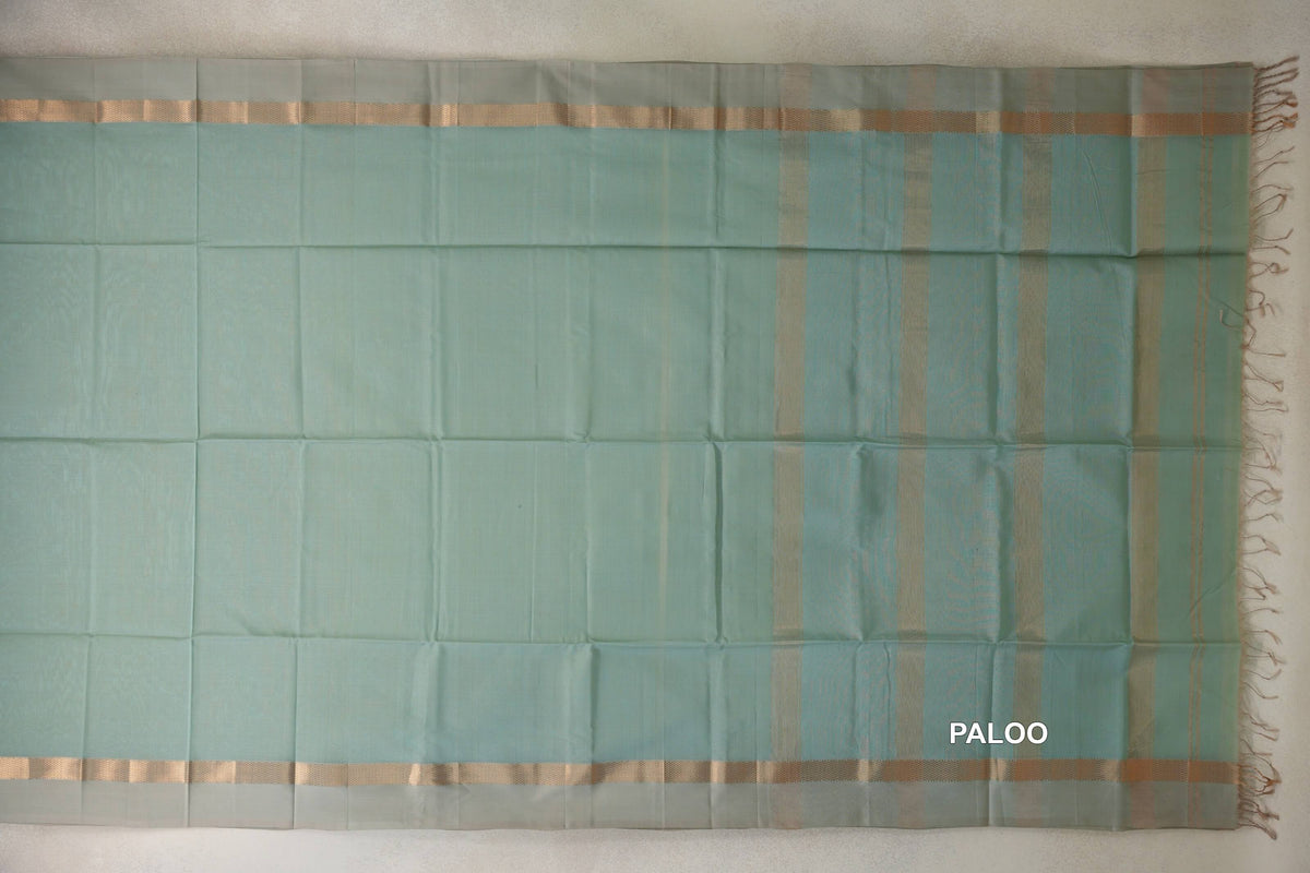 Sea green Maheshwari silk cotton saree pallu laid flat, with light sandal beige borders, vertical stripes and tassels along one edge.