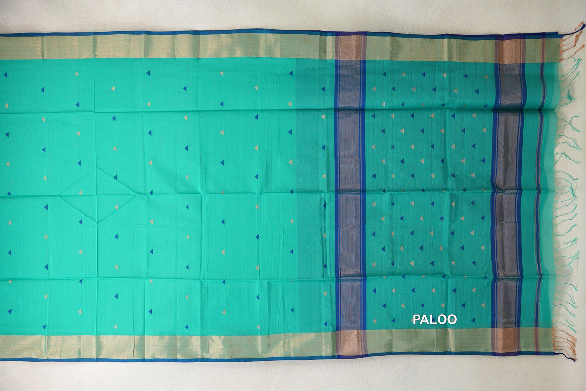 Sea Green Maheshwari silk cotton saree spread flat, with small blue and light triangles, pale borders, and a striped Classic Blue pallu with tassels.
