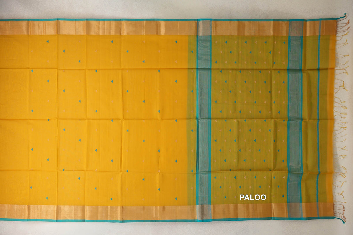 Mustard yellow Maheshwari silk cotton saree spread flat, with small triangular motifs, turquoise-edged borders and a striped pallu with tassels.
