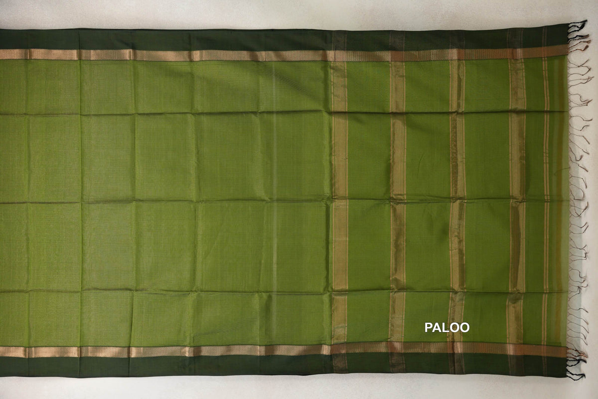 Olive green Maheshwari silk cotton saree laid flat, with deep forest green borders, gold-toned bands and a striped pallu with tassels.