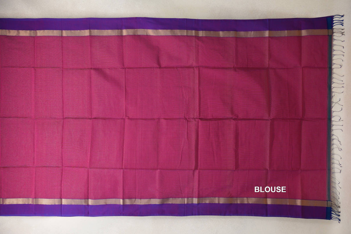 Deep rani pink Maheshwari silk cotton blouse piece spread flat, with violet purple borders, narrow gold-toned bands and tassels at one end.