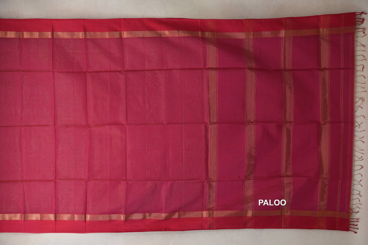 Rani pink Maheshwari silk cotton saree spread out, showing a plain body, deep pink borders, a striped pallu and tassels at the end.