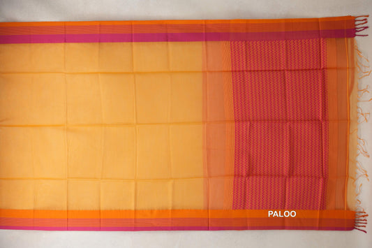 Maheshwari silk cotton saree spread flat, with a mango yellow body, orange and pink borders, and a rani pink zigzag pallu with orange tassels.