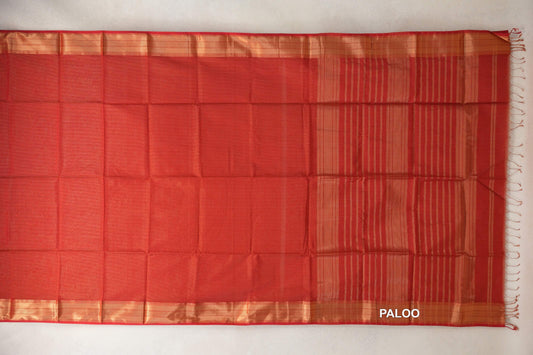 Tomato red Maheshwari silk cotton saree spread flat, with a plain body, gold-toned borders and a striped pallu with tassels.