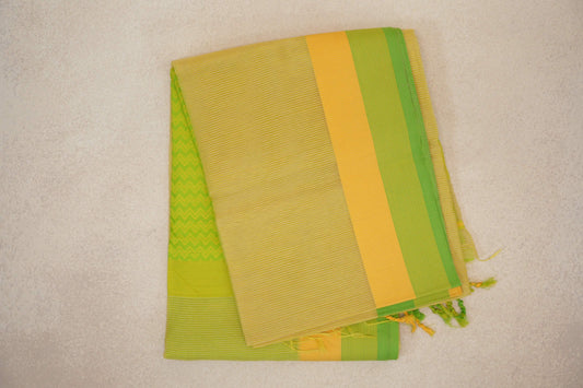 Folded lemon yellow Maheshwari silk cotton saree with fine stripes, a parrot green and yellow border, green zigzag detail and tassels.
