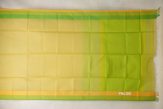 Maheshwari silk cotton saree spread flat, showing a lemon yellow body, parrot green and yellow borders, and a patterned green pallu with tassels.