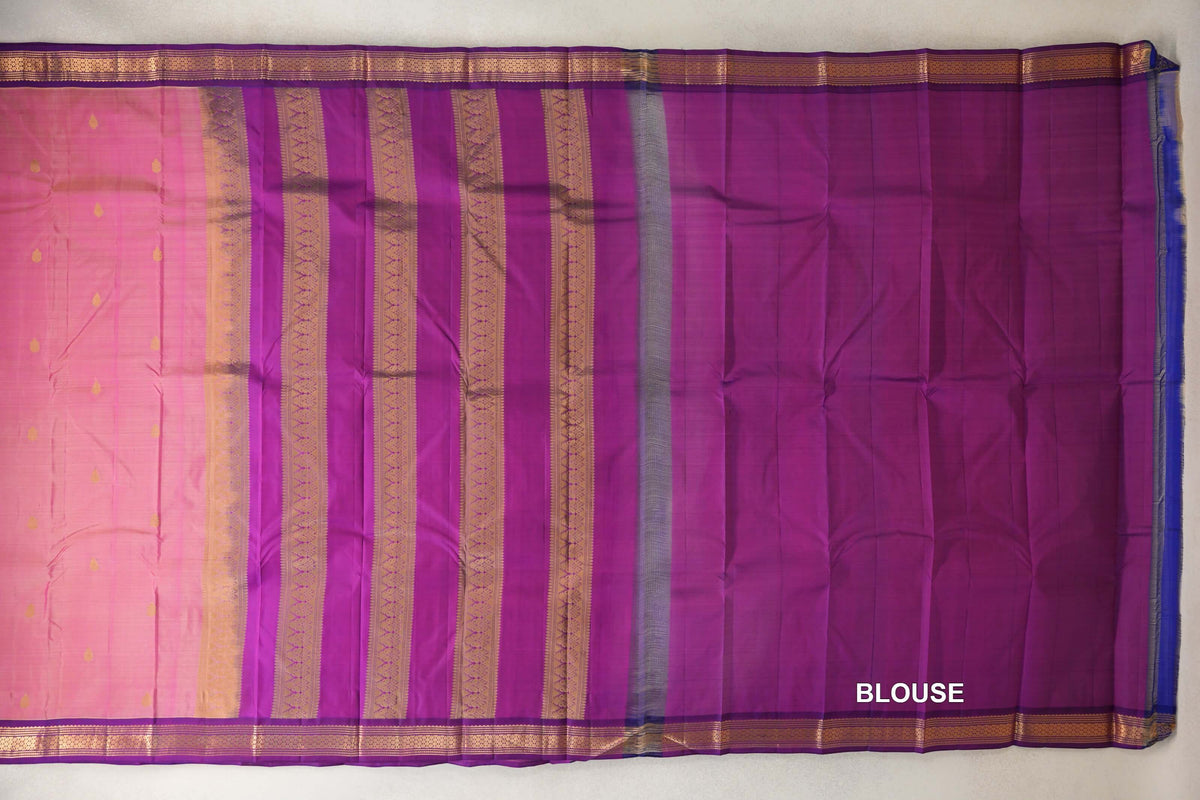 Lightweight Kanchipuram silk saree spread out, showing a rose pink body with small gold motifs, a striped purple pallu and a plain purple blouse section.
