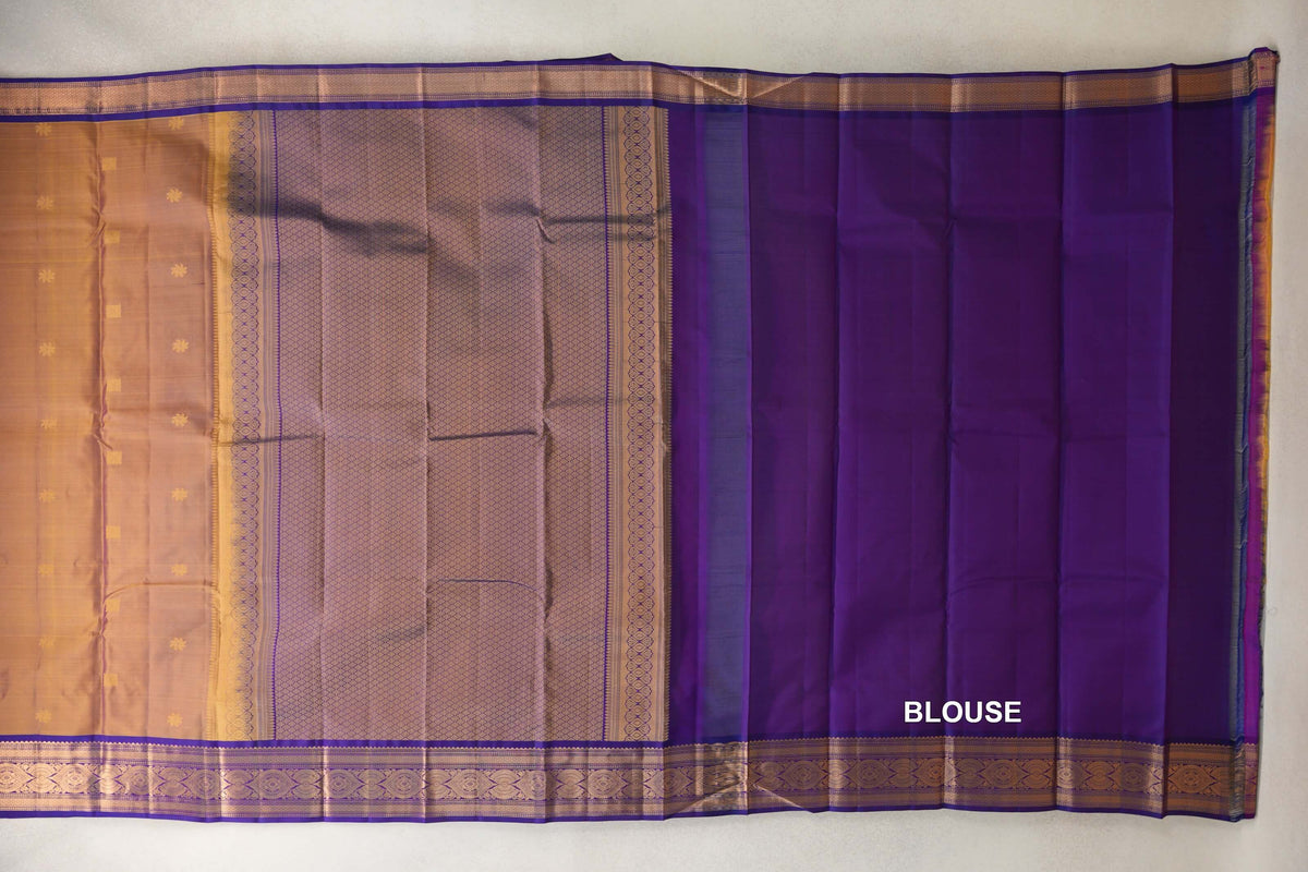 Light Weight Kanchipuram silk saree laid flat, showing a magenta and yellow body with small motifs, a patterned pallu and a violet purple blouse piece.
