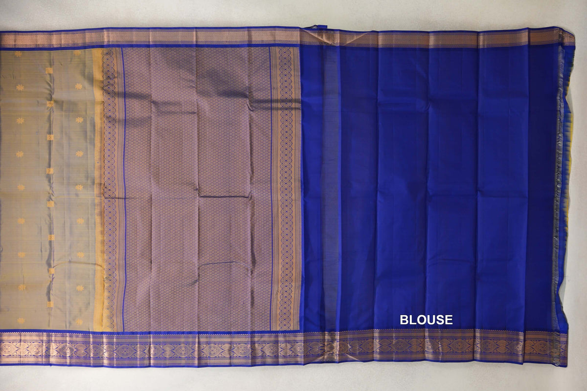 Spread-out Kanchipuram silk saree with a yellow-violet body, lattice-patterned pallu, deep royal blue blouse and ornate borders.