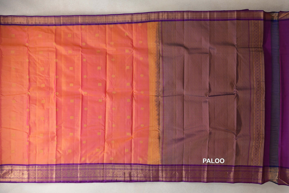 Spread-out light weight Kanchipuram silk saree with a pink and yellow body, small gold motifs, violet purple borders and a lattice-patterned pallu.