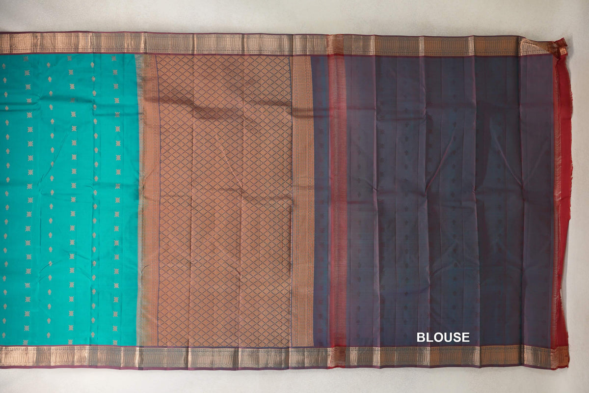 Peacock green Kanchipuram silk saree laid out with small motifs, a lattice-patterned pallu, patterned borders and a dark maroon blouse piece.