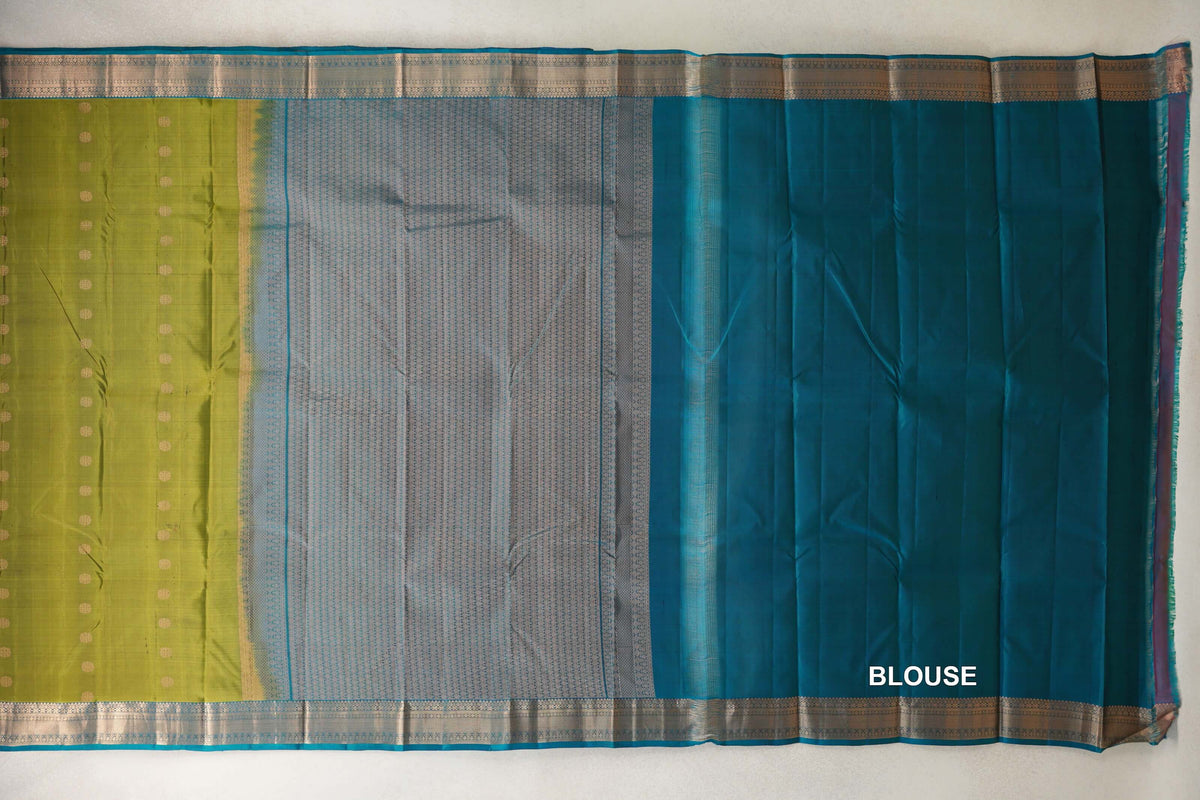 Laid-out light weight Kanchipuram silk saree with an olive green dotted body, patterned teal blue pallu, teal blue blouse piece and woven borders.