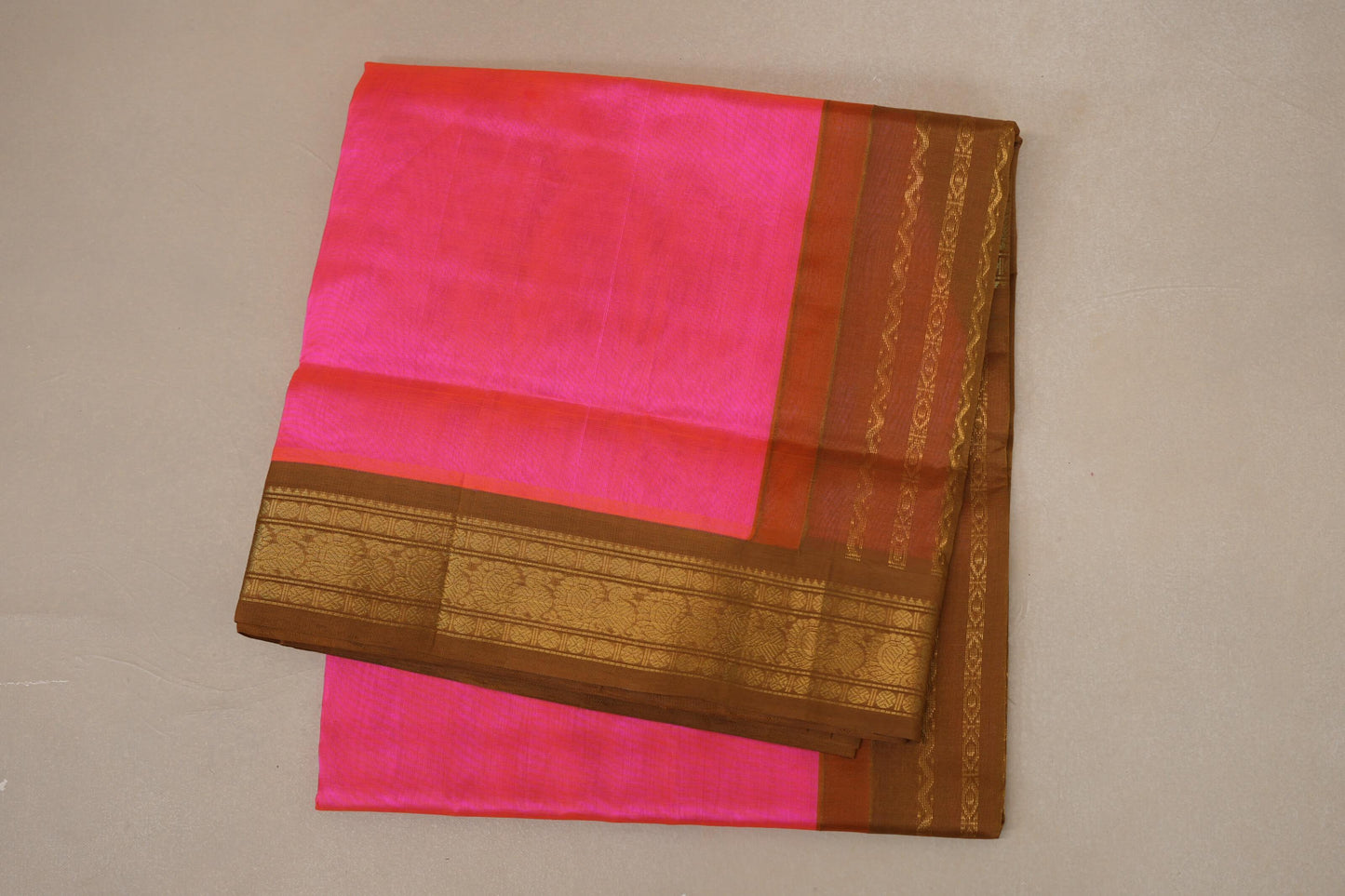 folded Bright Orangish Pink Silk Cotton Saree