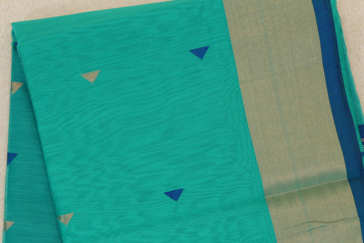 Folded sea green Maheshwari silk cotton saree with small blue and gold-toned triangles, a broad gold-toned border and classic blue selvedge.